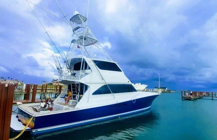 Killin Time Yacht Photos Pics 2003 Viking 65 Convertible Enclosed Bridge yacht docked under cloudy skies.