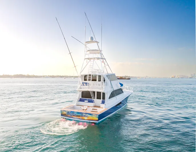 Killin Time Yacht Photos Pics 2003 Viking 65 Convertible Enclosed Bridge yacht cruising on open water.