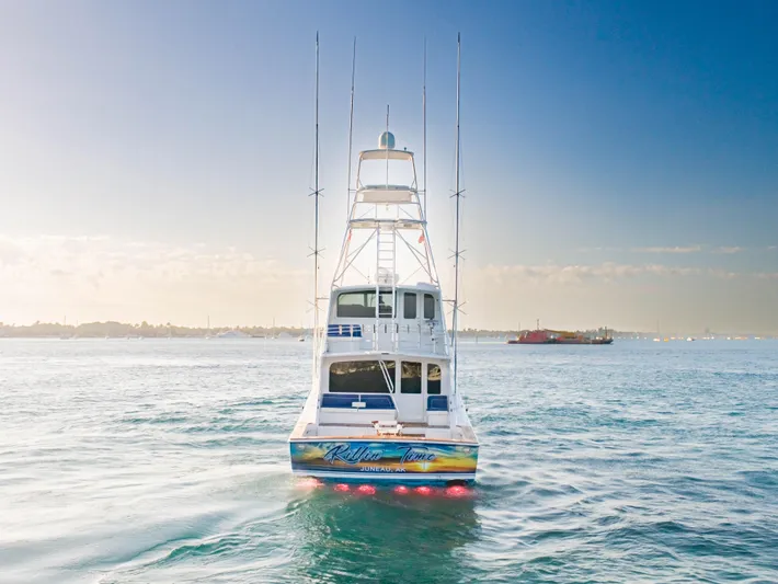 Killin Time Yacht Photos Pics 2003 Viking 65 Convertible Enclosed Bridge yacht on open water, rear view.