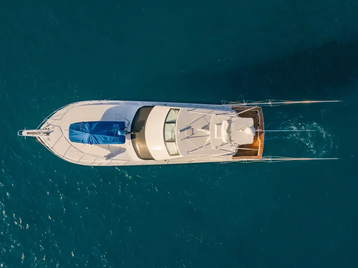 Killin Time Yacht Photos Pics Aerial view of 2003 Viking 65 Convertible Enclosed Bridge yacht on blue water.