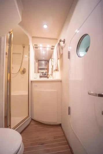 Killin Time Yacht Photos Pics Bathroom interior of 2003 Viking 65 Convertible Enclosed Bridge yacht, featuring shower and porthole.
