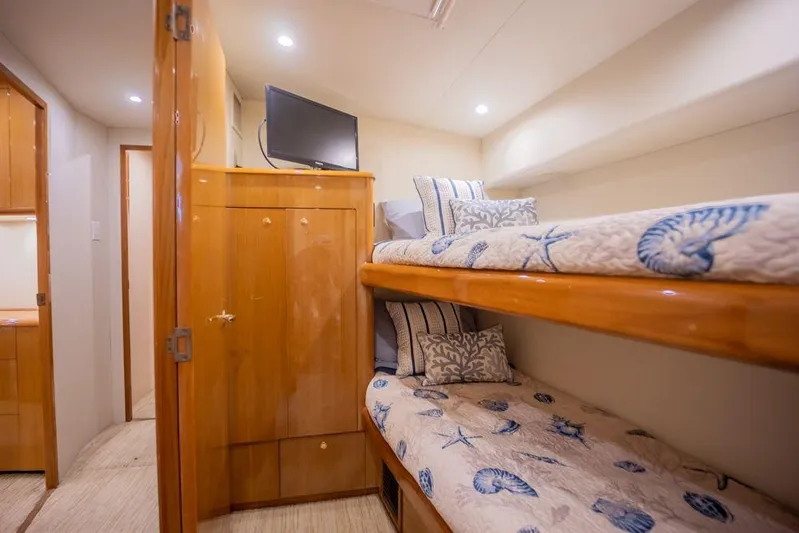 Killin Time Yacht Photos Pics Interior of 2003 Viking 65 Convertible yacht with cozy bunk beds and wooden cabinetry.