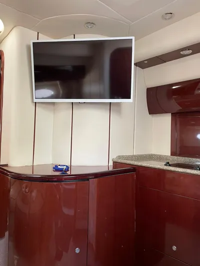  Yacht Photos Pics Interior of 2006 Princess V42 yacht with TV and glossy wood finish.