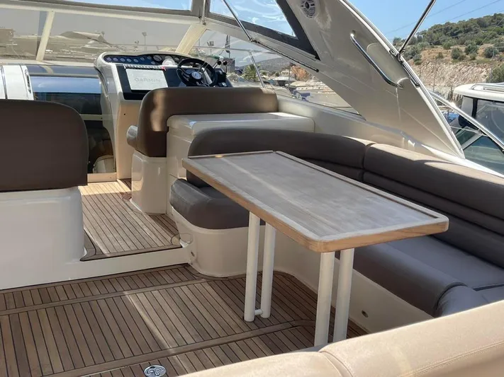  Yacht Photos Pics 2006 Princess V42 yacht interior with seating and wooden table.