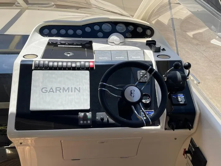  Yacht Photos Pics Helm of 2006 Princess V42 yacht with Garmin navigation system and steering wheel.