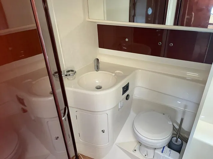  Yacht Photos Pics Bathroom interior of a 2006 Princess V42 yacht, featuring a sink and toilet.