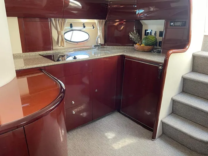  Yacht Photos Pics Luxurious kitchen interior of 2006 Princess V42 yacht with sleek cabinetry and modern appliances.