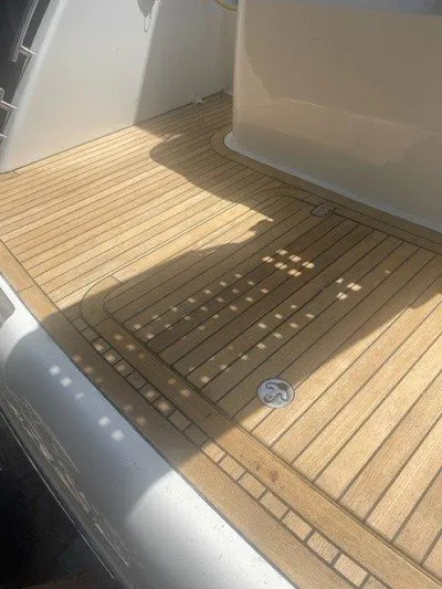  Yacht Photos Pics Teak deck of a 2006 Princess V42 yacht, showcasing elegant wood finish.