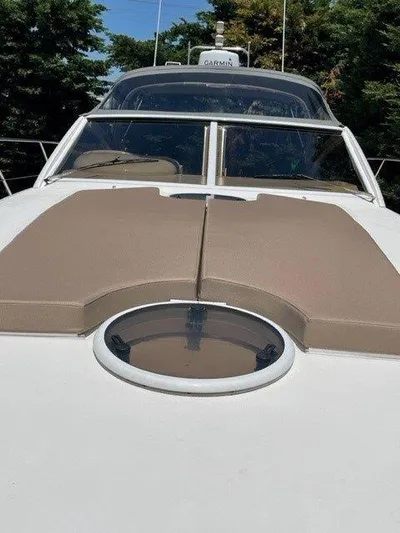  Yacht Photos Pics 2006 Princess V42 yacht with sunbathing cushions and circular hatch on deck.