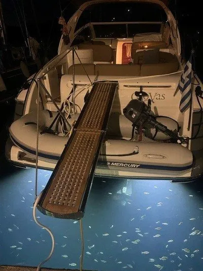  Yacht Photos Pics 2006 Princess V42 yacht with illuminated water and fish at night.