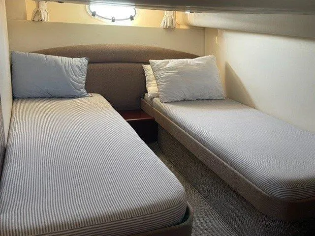  Yacht Photos Pics Twin beds in a 2006 Princess V42 yacht cabin, featuring cozy bedding and soft lighting.
