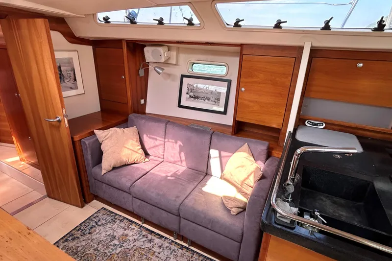 Scacciapensieri Yacht Photos Pics Interior of 2008 Hanse 470e yacht with cozy seating and modern kitchen area.
