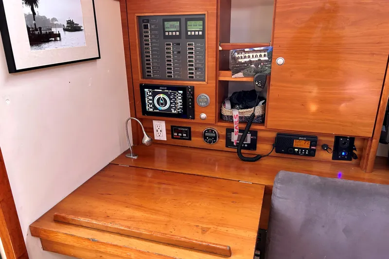 Scacciapensieri Yacht Photos Pics Navigation station of 2008 Hanse 470e yacht with control panels and communication equipment.