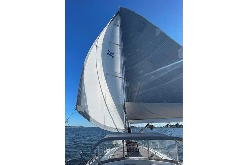 Scacciapensieri Yacht Photos Pics Sailing on a 2008 Hanse 470e yacht with full sails under a clear blue sky.