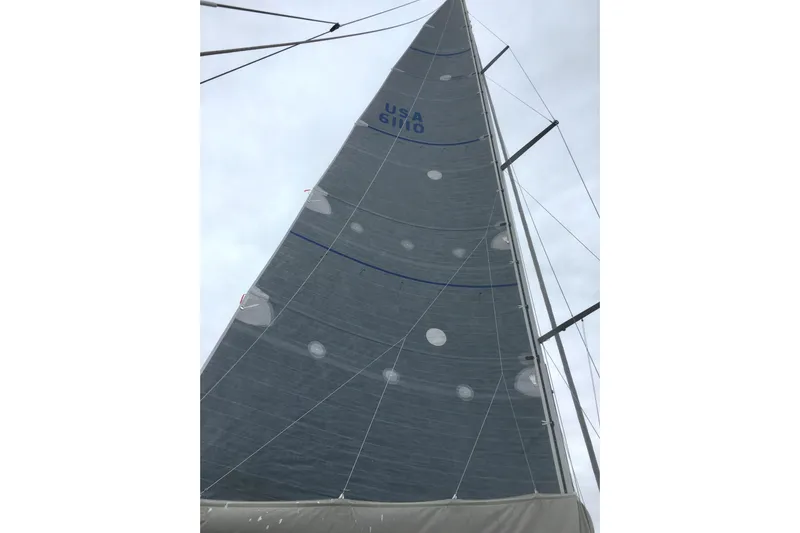 Scacciapensieri Yacht Photos Pics Sail of 2008 Hanse 470e yacht against cloudy sky, showcasing rigging details.