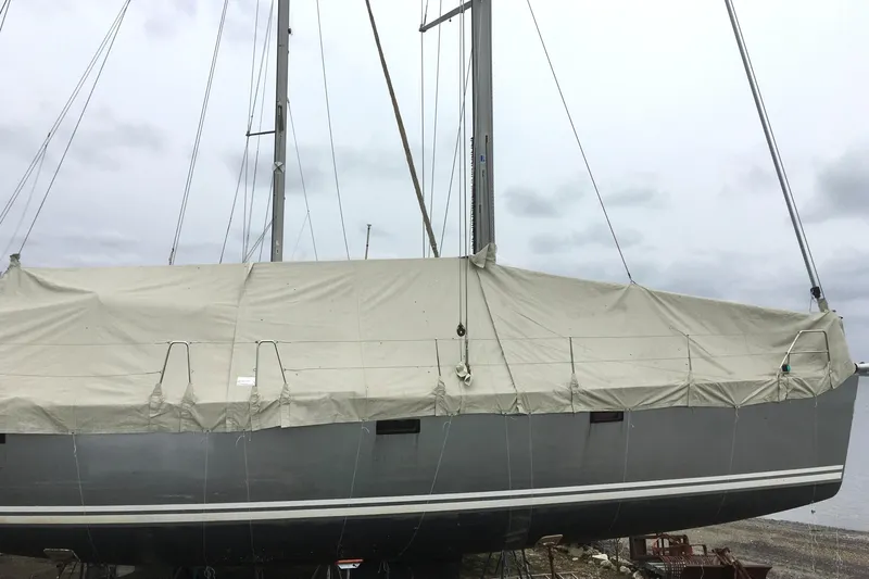 Scacciapensieri Yacht Photos Pics 2008 Hanse 470e sailboat covered with tarp, docked on a cloudy day.