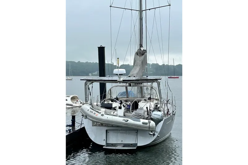 Scacciapensieri Yacht Photos Pics Sailboat Hanse 470e 2008 docked with dinghy, overcast sky in background.