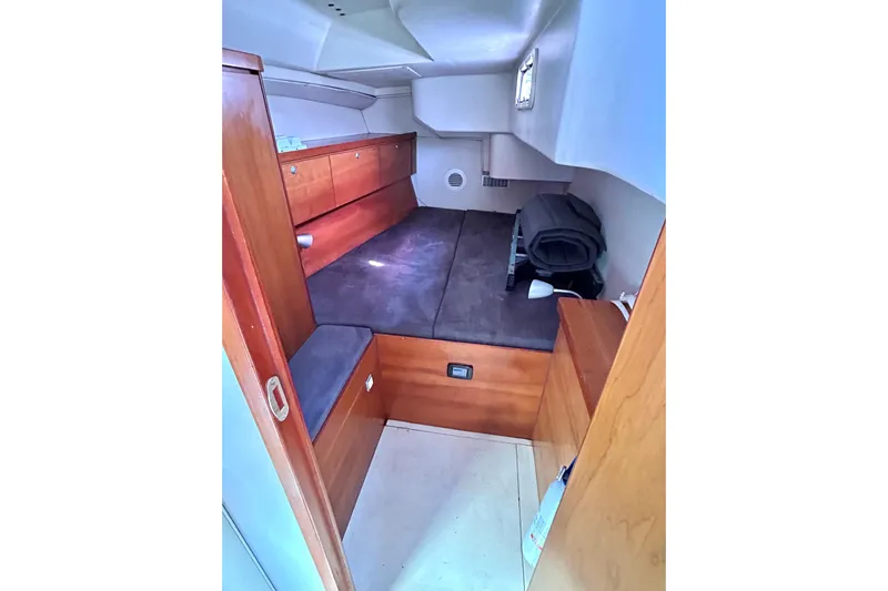 Scacciapensieri Yacht Photos Pics Cozy cabin interior of 2008 Hanse 470e sailboat with wooden furnishings.