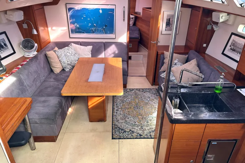 Scacciapensieri Yacht Photos Pics Interior of 2008 Hanse 470e yacht with cozy seating, dining table, and kitchenette.
