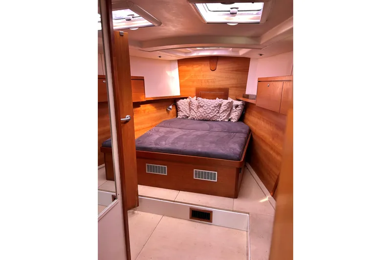 Scacciapensieri Yacht Photos Pics Luxurious cabin interior of 2008 Hanse 470e yacht with cozy bedding.