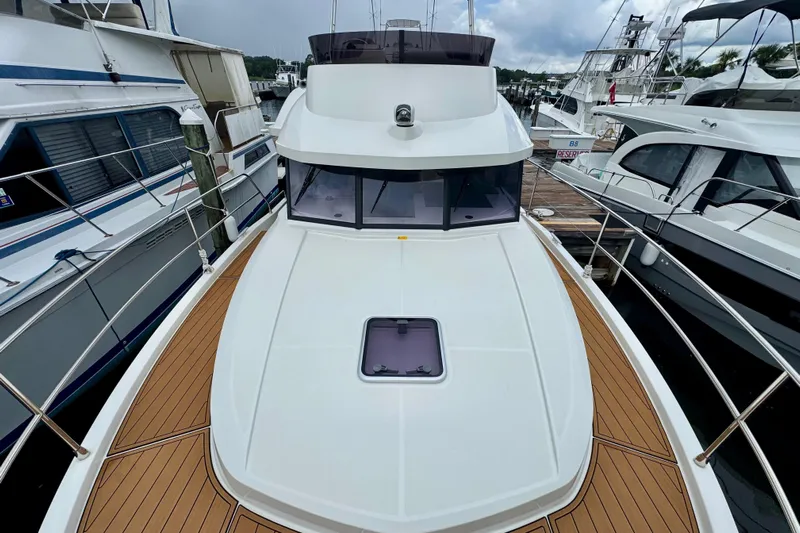  Yacht Photos Pics 2025 Beneteau Swift Trawler 35 docked, showcasing sleek design and spacious deck.