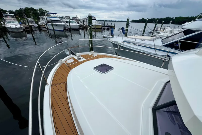  Yacht Photos Pics 2025 Beneteau Swift Trawler 35 docked at a marina under cloudy skies.