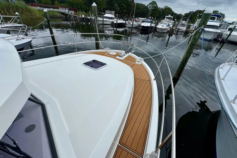  Yacht Photos Pics 2025 Beneteau Swift Trawler 35 docked, showcasing sleek deck design and marina setting.