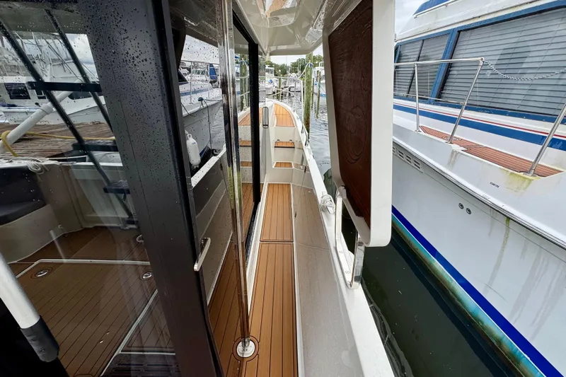  Yacht Photos Pics 2025 Beneteau Swift Trawler 35, sleek deck view with wooden flooring and modern design.