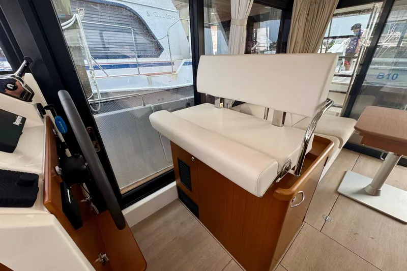  Yacht Photos Pics Interior of 2025 Beneteau Swift Trawler 35 with helm seat and steering wheel.