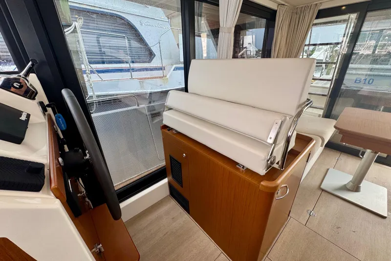  Yacht Photos Pics Interior of 2025 Beneteau Swift Trawler 35, featuring helm and seating area.