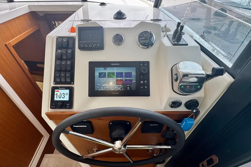  Yacht Photos Pics 2025 Beneteau Swift Trawler 35 helm with advanced navigation controls and digital display.