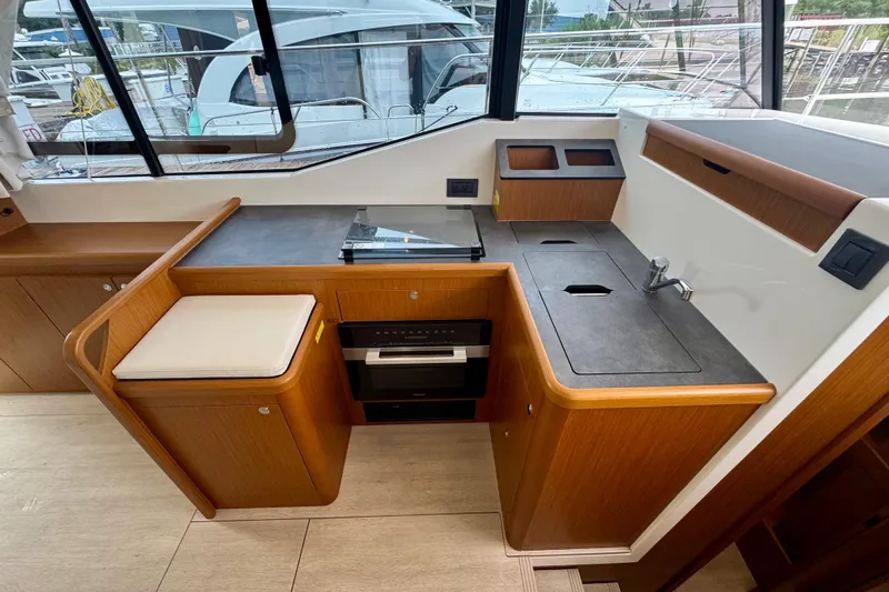  Yacht Photos Pics Modern kitchen area in 2025 Beneteau Swift Trawler 35, featuring sleek countertops and compact design.