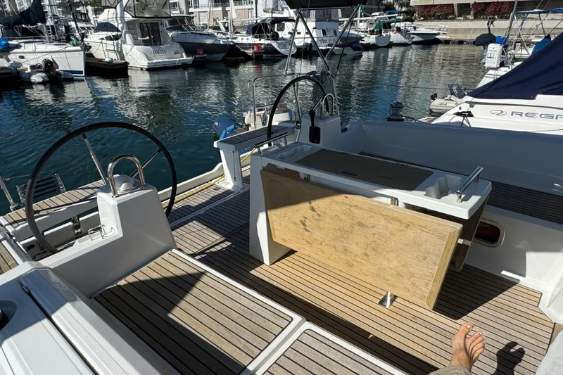 Moonraker Yacht Photos Pics Cockpit of 2014 Beneteau Oceanis 38 yacht docked at marina, featuring dual steering wheels.