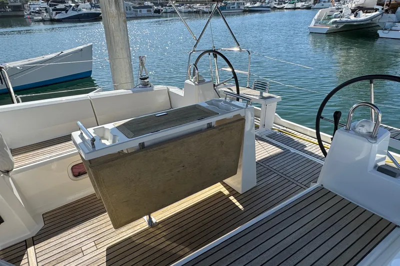 Moonraker Yacht Photos Pics 2014 Beneteau Oceanis 38 sailboat cockpit with dual steering wheels and wooden deck.