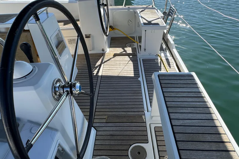 Moonraker Yacht Photos Pics Cockpit of 2014 Beneteau Oceanis 38 sailboat with dual steering wheels and teak decking.
