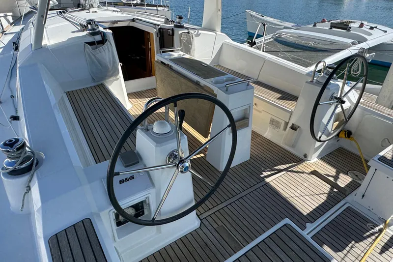 Moonraker Yacht Photos Pics Cockpit of 2014 Beneteau Oceanis 38 sailboat with dual steering wheels and teak decking.