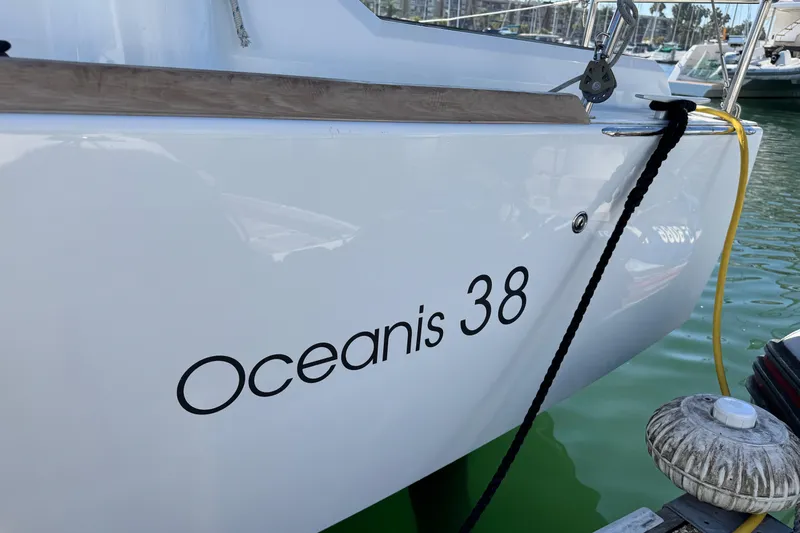 Moonraker Yacht Photos Pics 2014 Beneteau Oceanis 38 sailboat docked, showcasing sleek white hull design.