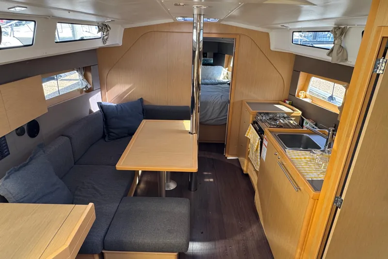 Moonraker Yacht Photos Pics Interior of 2014 Beneteau Oceanis 38 sailboat with cozy seating and compact kitchen.