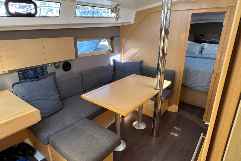 Moonraker Yacht Photos Pics Interior of 2014 Beneteau Oceanis 38 sailboat with cozy seating and dining area.