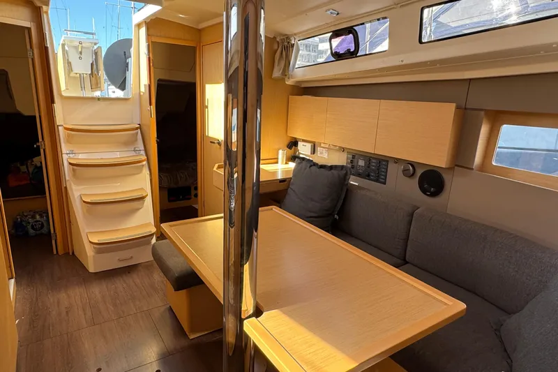 Moonraker Yacht Photos Pics Interior of 2014 Beneteau Oceanis 38 sailboat with modern wood finish and cozy seating.