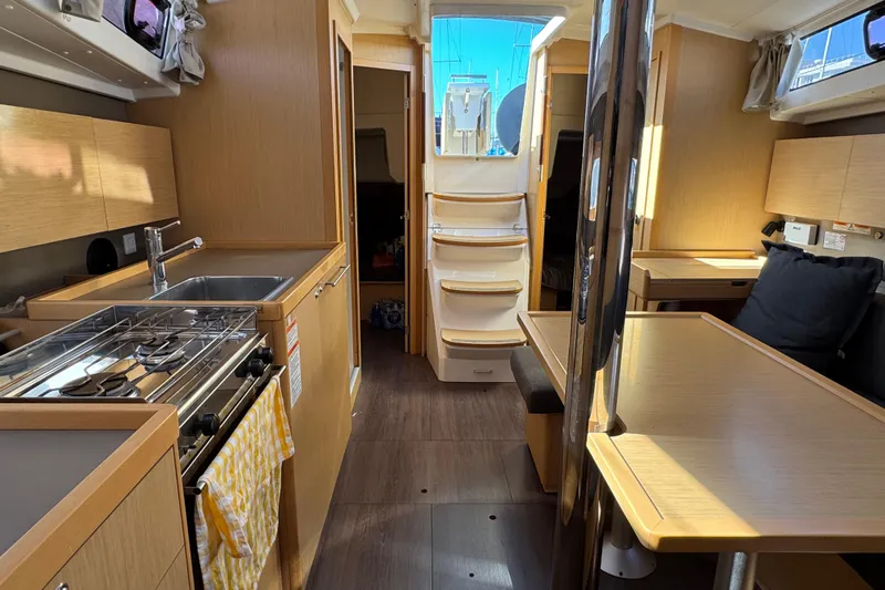 Moonraker Yacht Photos Pics Interior of 2014 Beneteau Oceanis 38 sailboat, featuring modern kitchen and dining area.