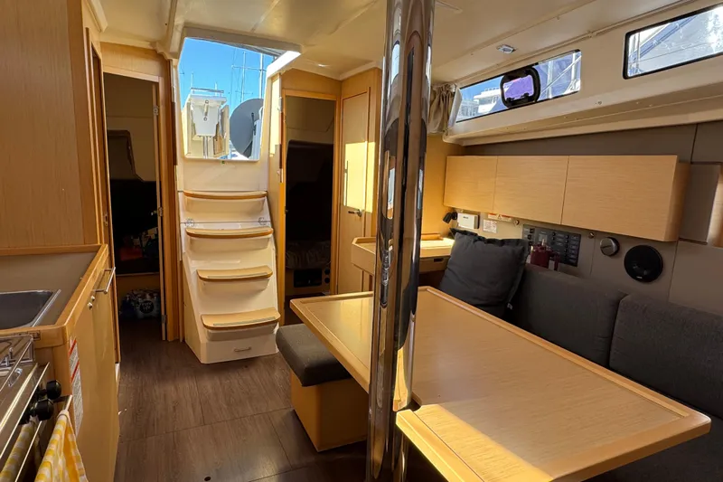 Moonraker Yacht Photos Pics Interior of 2014 Beneteau Oceanis 38 sailboat with modern wood finish and seating area.