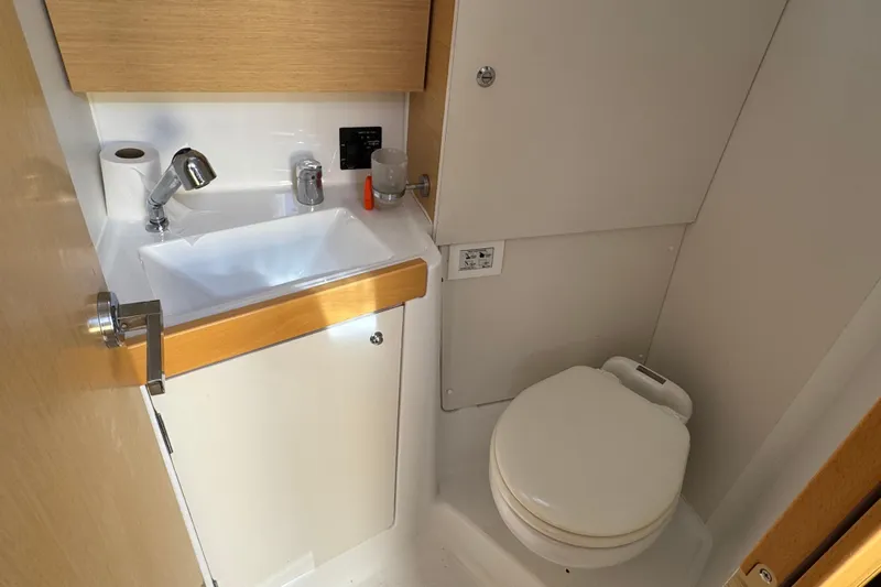 Moonraker Yacht Photos Pics Bathroom interior of 2014 Beneteau Oceanis 38 yacht, featuring sink and toilet.