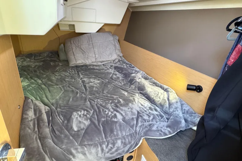 Moonraker Yacht Photos Pics Cozy cabin interior of 2014 Beneteau Oceanis 38 sailboat with bed and soft bedding.
