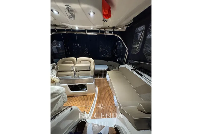  Yacht Photos Pics 2008 Cranchi Zaffiro 36 interior with seating, wood flooring, and overhead lighting.