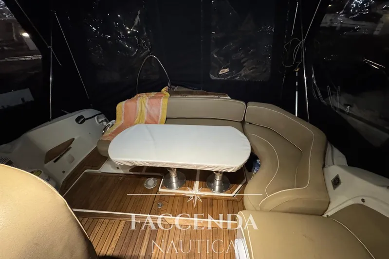  Yacht Photos Pics Interior of 2008 Cranchi Zaffiro 36 yacht with seating and table, nighttime setting.