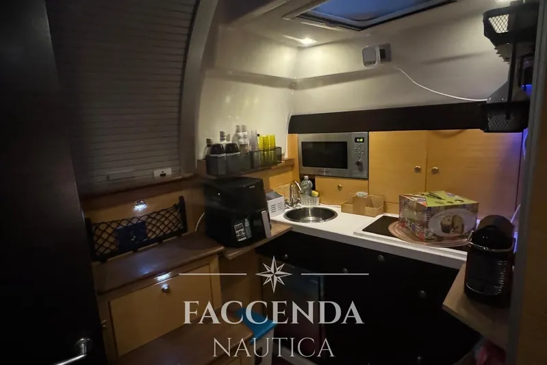  Yacht Photos Pics Compact kitchen area inside a 2008 Cranchi Zaffiro 36 yacht, featuring modern amenities.