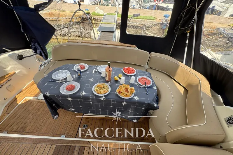  Yacht Photos Pics 2008 Cranchi Zaffiro 36 yacht interior with dining setup on a star-patterned tablecloth.