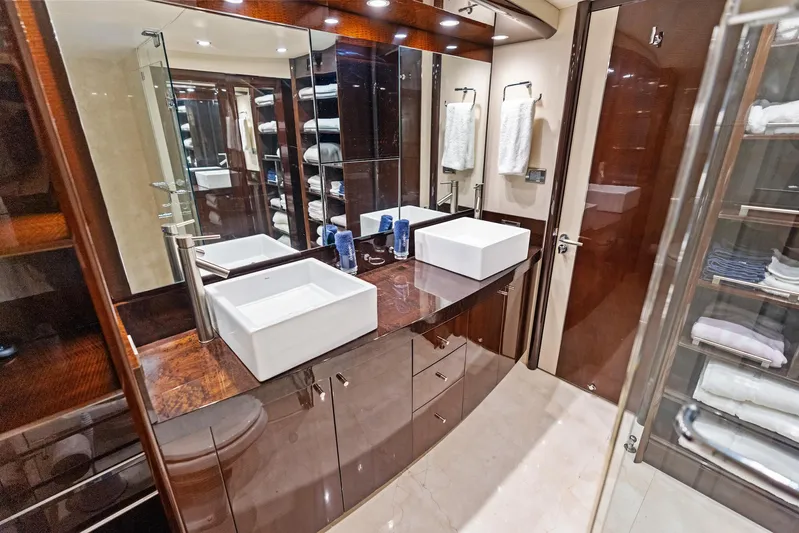 Liquid Asset Yacht Photos Pics Luxurious bathroom in 2010 Lazzara 78 Fly yacht with dual sinks and elegant wood finishes.