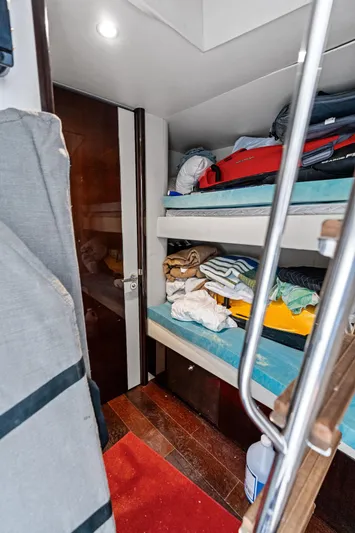 Liquid Asset Yacht Photos Pics Bunk beds in a 2010 Lazzara 78 Fly yacht cabin with storage and luggage.